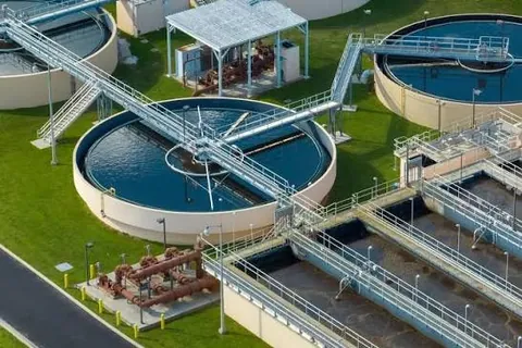 Circular clarifier tanks at a sewage treatment plant, shown as an illustration