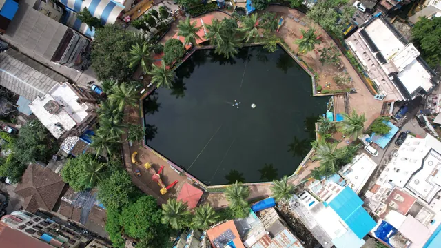 Aerial view of Rao Talao, Mira Bhayandar, during the ongoing project, with darker water and a floating unit mid-lake